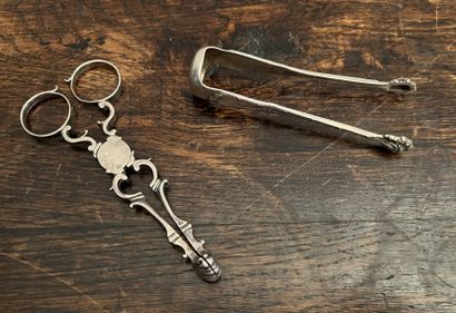 Two silver (925) sugar tongs, one in the...