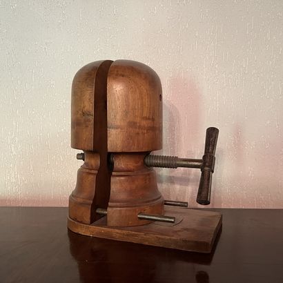 Antique wooden hat form with metal screws....