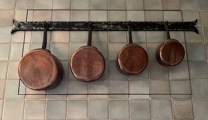 Set of red copper kitchen utensils: saucepans,...