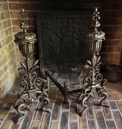 Pair of patinated wrought-iron landiers decorated...
