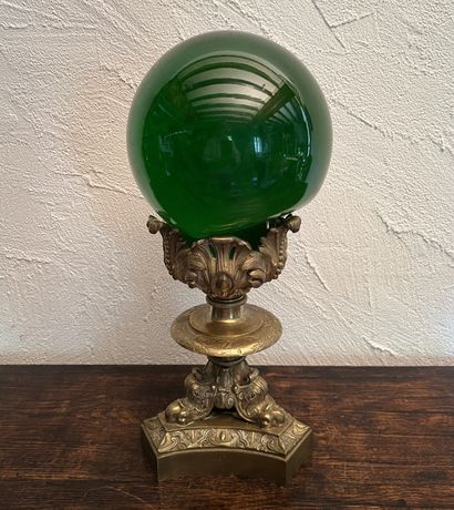 Large green-tinted glass ball on a gilt bronze...