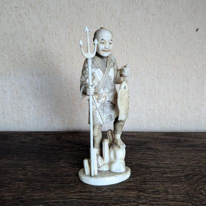 Ivory okimono featuring a fisherman with...