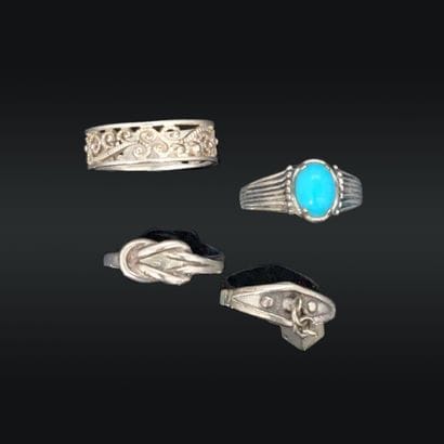 Quatre bagues en argent (800), l'une ornée...