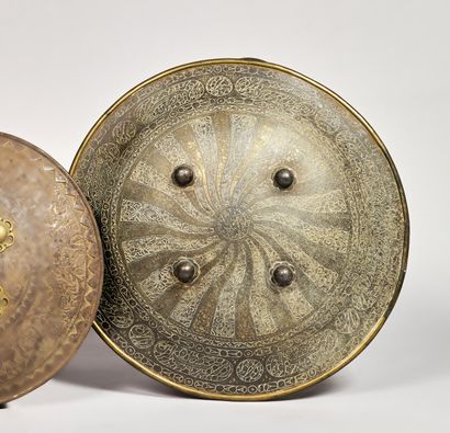 Large steel and brass rondache, the center...