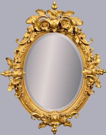 Large mirror, the oval frame decorated with...
