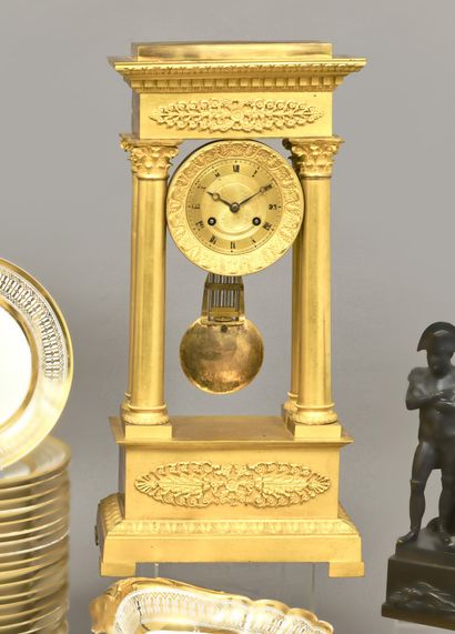 Portico clock in gilded bronze, the dial...