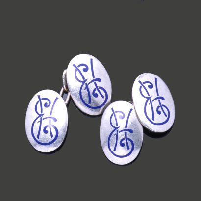 A pair of platinum cufflinks, each featuring...