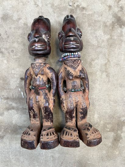 A pair of Ibeji twins in patinated wood,...