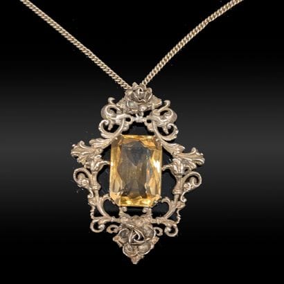 Silver pendant (800), holding in its center...