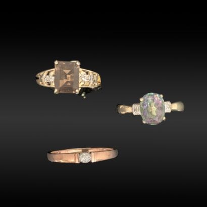 Three metal rings: - a ring set with small...
