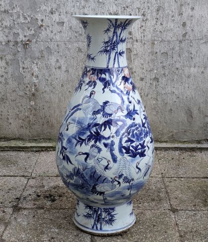 A large pear-shaped porcelain vase on a heel,...