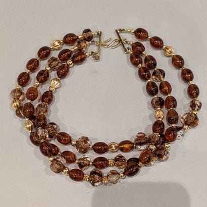 Christian DIOR. Three-row fancy necklace...