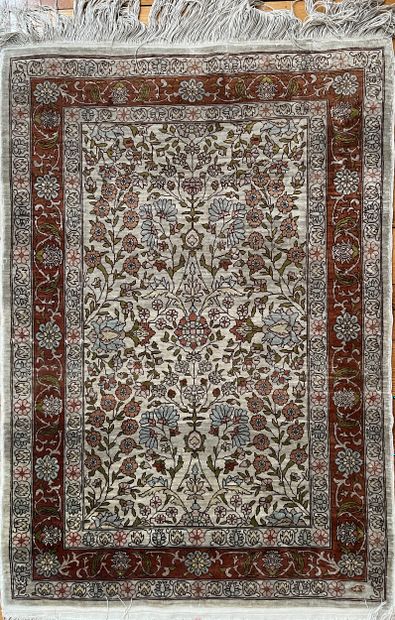 Petit tapis en laine et soie. A décor floral...