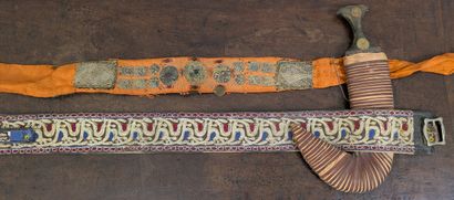 *Curved-blade dagger in its scabbard and...