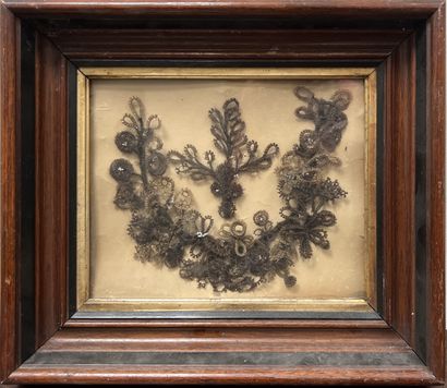 *Hair-decorated frame with a garland of flowers....