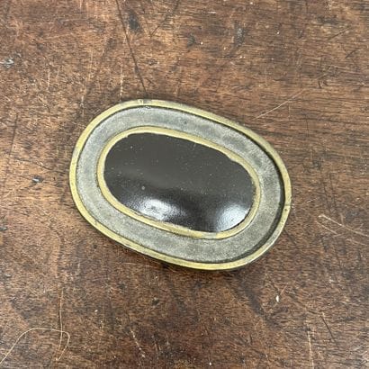 *Yves SAINT-LAURENT. Metal and leather oval...