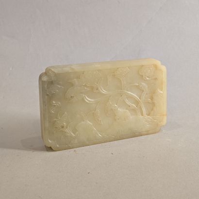 A jadeite plaque, the corners redent, engraved...