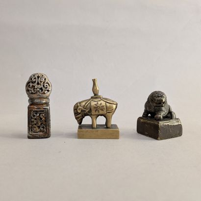 Set: - bronze seal featuring a cowed elephant....