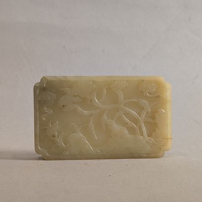 A jadeite plaque, the corners redent, engraved...