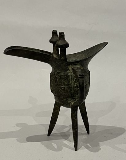 China. Jue bronze wine cup, standing on three...