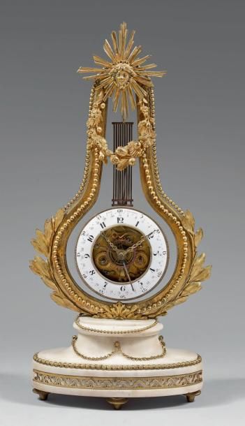 Pendule lyre en marbre blanc et bronze doré...