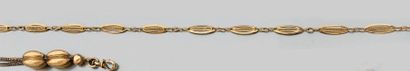 Collier souple en or jaune, composé de motifs...