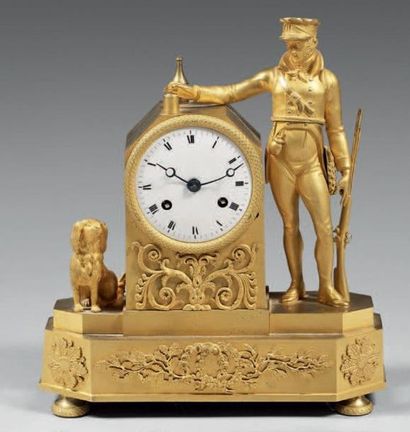 Pendule en bronze doré représentant un chasseur...