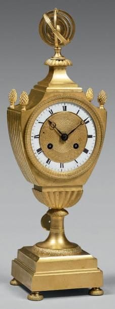 Pendule en forme d'écusson en bronze doré,...