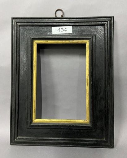 Blackened moulded wooden frame with reversed...