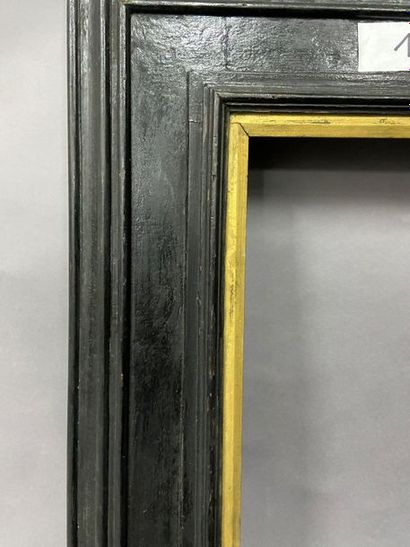 Blackened moulded wooden frame with reversed...