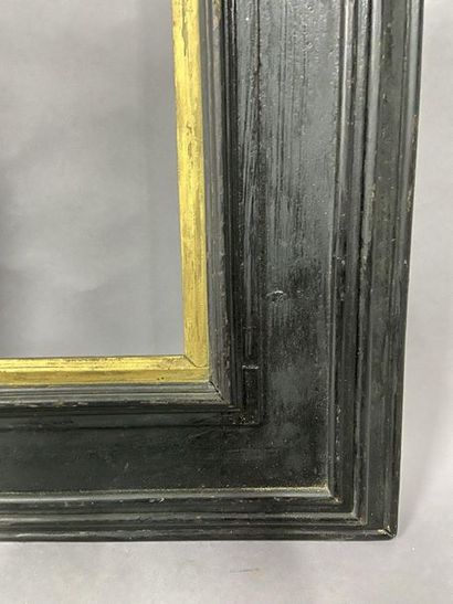 Blackened moulded wooden frame with reversed...