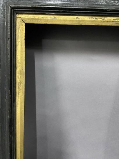 Blackened moulded wooden frame with reversed...
