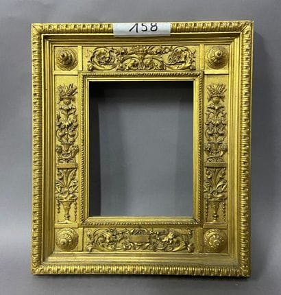 Carved and gilded wood frame with openwork...