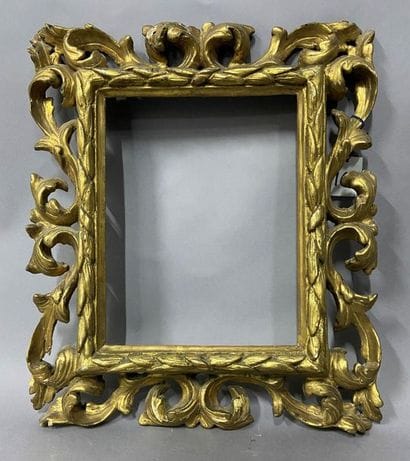 Carved and openworked gilded linden frame...