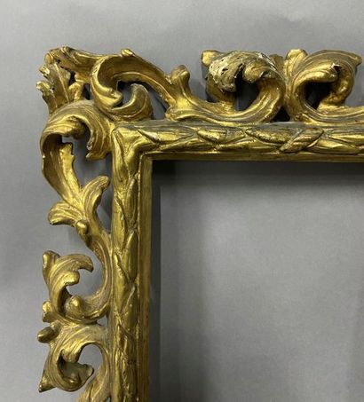 Carved and openworked gilded linden frame...
