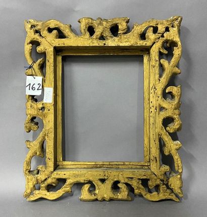 Carved and openworked gilded linden frame...