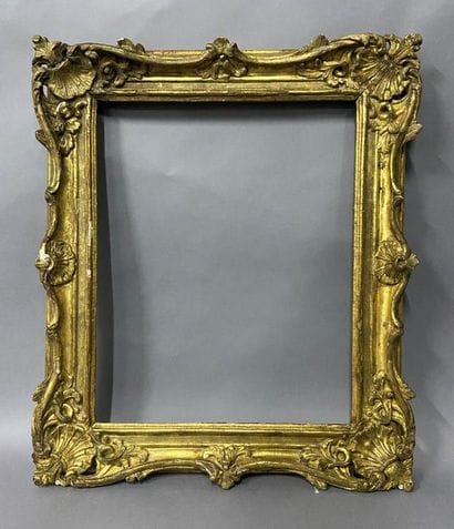 Sculpted and gilded lindenwood frame decorated...