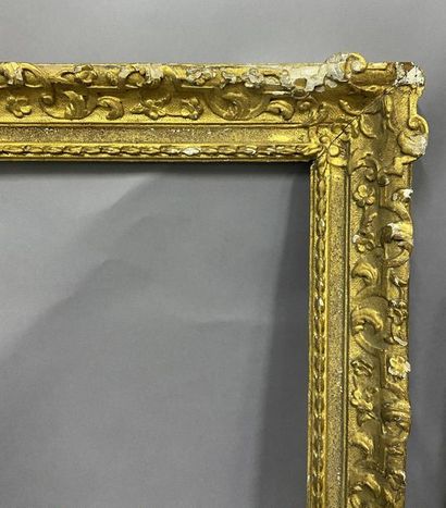 Carved and gilded oak frame with Bérain decoration...