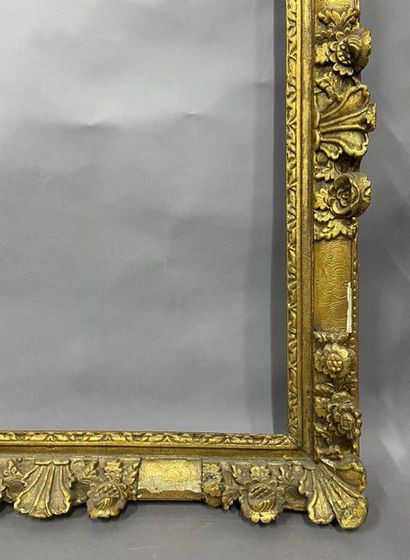 Sculpted and gilded oak frame with flower...