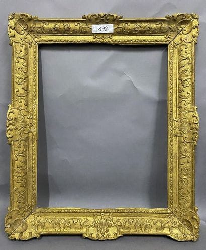 Carved and gilded oak frame with Bérain decoration...