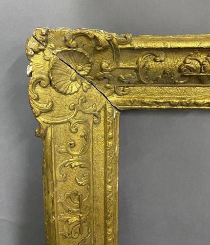 Carved and gilded oak frame with Bérain decoration...