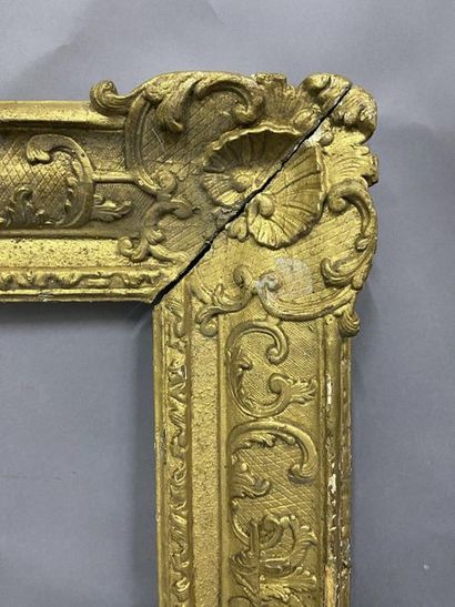Carved and gilded oak frame with Bérain decoration...