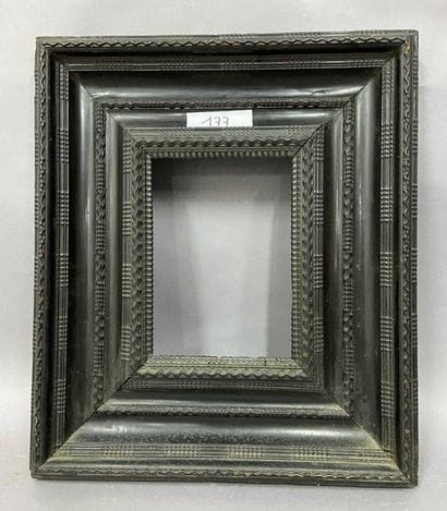Wooden frame and blackened wood veneer decorated...