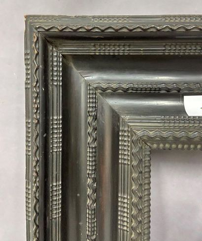 Wooden frame and blackened wood veneer decorated...