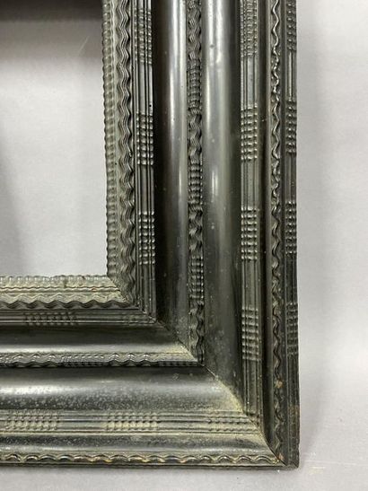 Wooden frame and blackened wood veneer decorated...