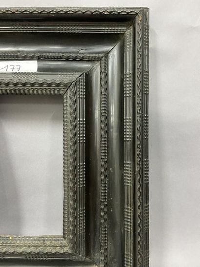 Wooden frame and blackened wood veneer decorated...