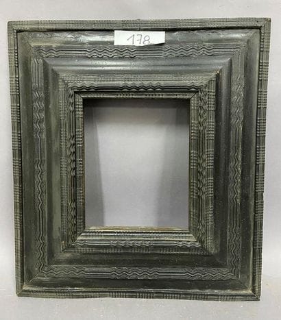 Moulded and blackened satin frame with an...