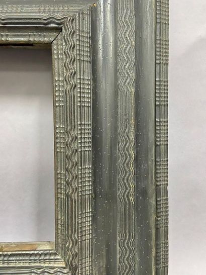 Moulded and blackened satin frame with an...