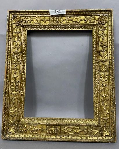 Carved and gilded wood frame with rich decoration...