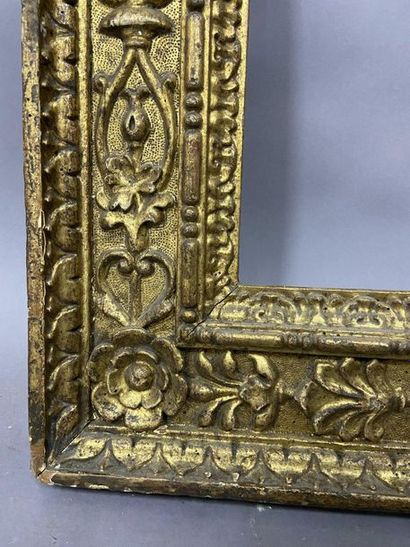 Carved and gilded wood frame with rich decoration...